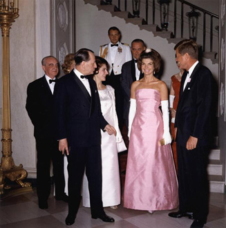 Jacqueline shimmers in a pink silk dress, which sets off her tan beautifully, with French Minister of Culture, Malraux and President Kennedy 